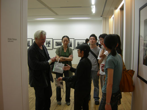Anders Petersen talking to guests at the opening of his exhibition at Rat Hole Gallery.