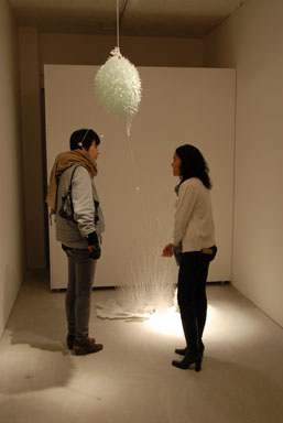 Shoko Matsumiya (right) talking to a guest about her work.