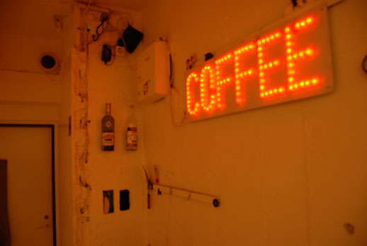 This coffee sign hangs in the hallway like a permanent exhibit of sorts, colouring the hallway with its orange glow.