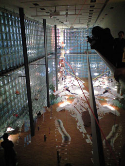 Carefully placed mirror tiles make it look as though the installation includes a gaping hole communicating with the floor below