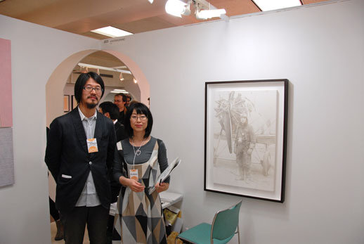 Kosuke Fujitaka, one of the co-founders of 101Tokyo, with Tomoko Aratani of Arataniurano (Tokyo), which is showing paintings by Yoichi Umetsu.