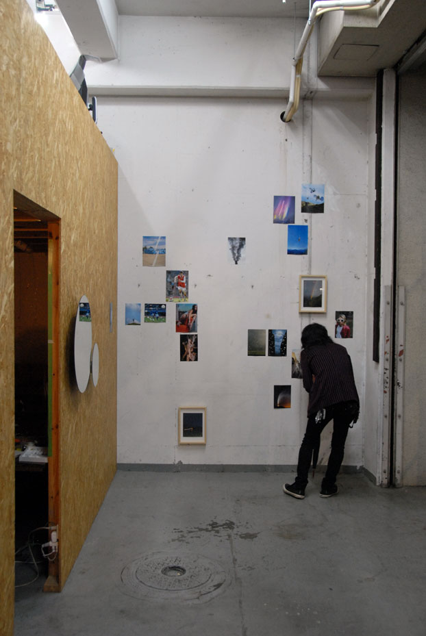 Hideki Aoyama collaborates with Schemata under the collective name 'happa', and they share the space, but tonight's opening is an Aoyama | Meguro production. Here, a visitor peers closely at Morita's collaged photography work.