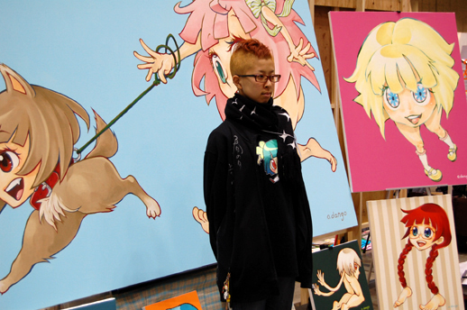 Dango Ozawa poses with her anime-inspired paintings.