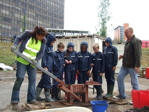 David Pollard and workshop participants using a brick machine in Birmingham, UK.