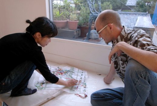 Sayaka Akiyama (left) explains her work.
