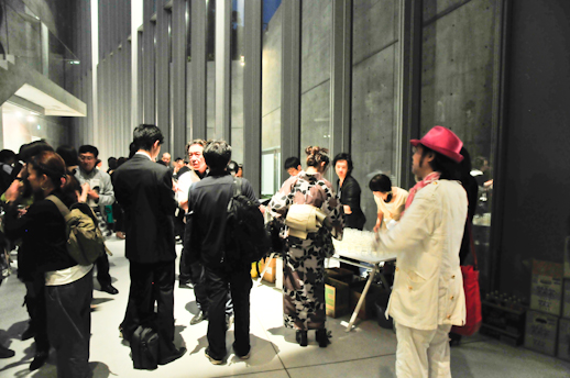 People enjoying the party drinking cold white wine, and sake in bottles designed by Hara design.