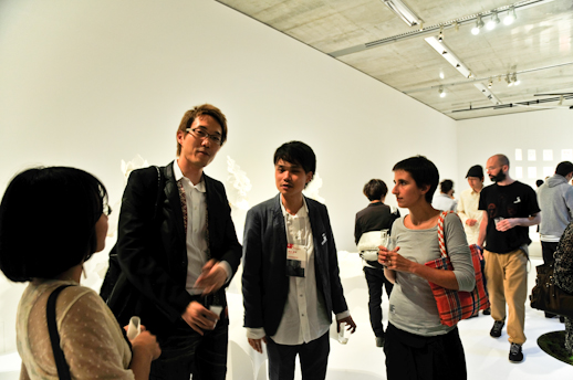 Designer Nendo discussing the exhibition with architects from Kengo Kuma office.