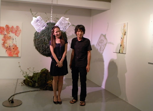 The owner Yuka Tsuruno and the artist Adachi Kiichiro pose for a celebratory photo. Tsuruno is drawing upon her experience living in New York and wants her gallery to be a crossing point for international artist exchanges.