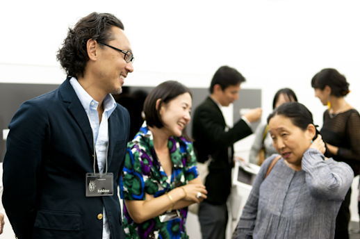 Exhibitors and visitors talking at Taro Nasu Gallery.