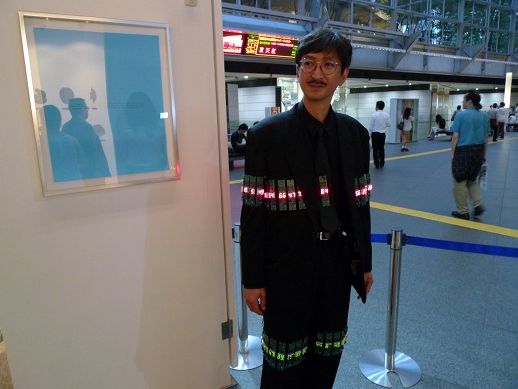 It's revealing, though, when the best art is displayed on the visitors' clothing! Here artist Junichi Kusaka models what he claimed was a genuine Tatsuo Miyajima installation of LED numbers.