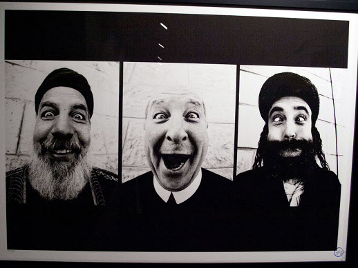 JR's triptych of a Muslim holy man, a Catholic priest, and a Rabbi. According to Magda Danysz Gallery, the Muslim man is on the Israeli side of the border. The Rabbi and Catholic are on the Palestinian side.
